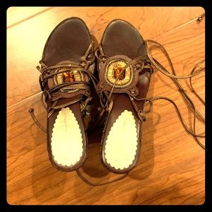 Brown bronze wedges that wrap up the calf and tie.